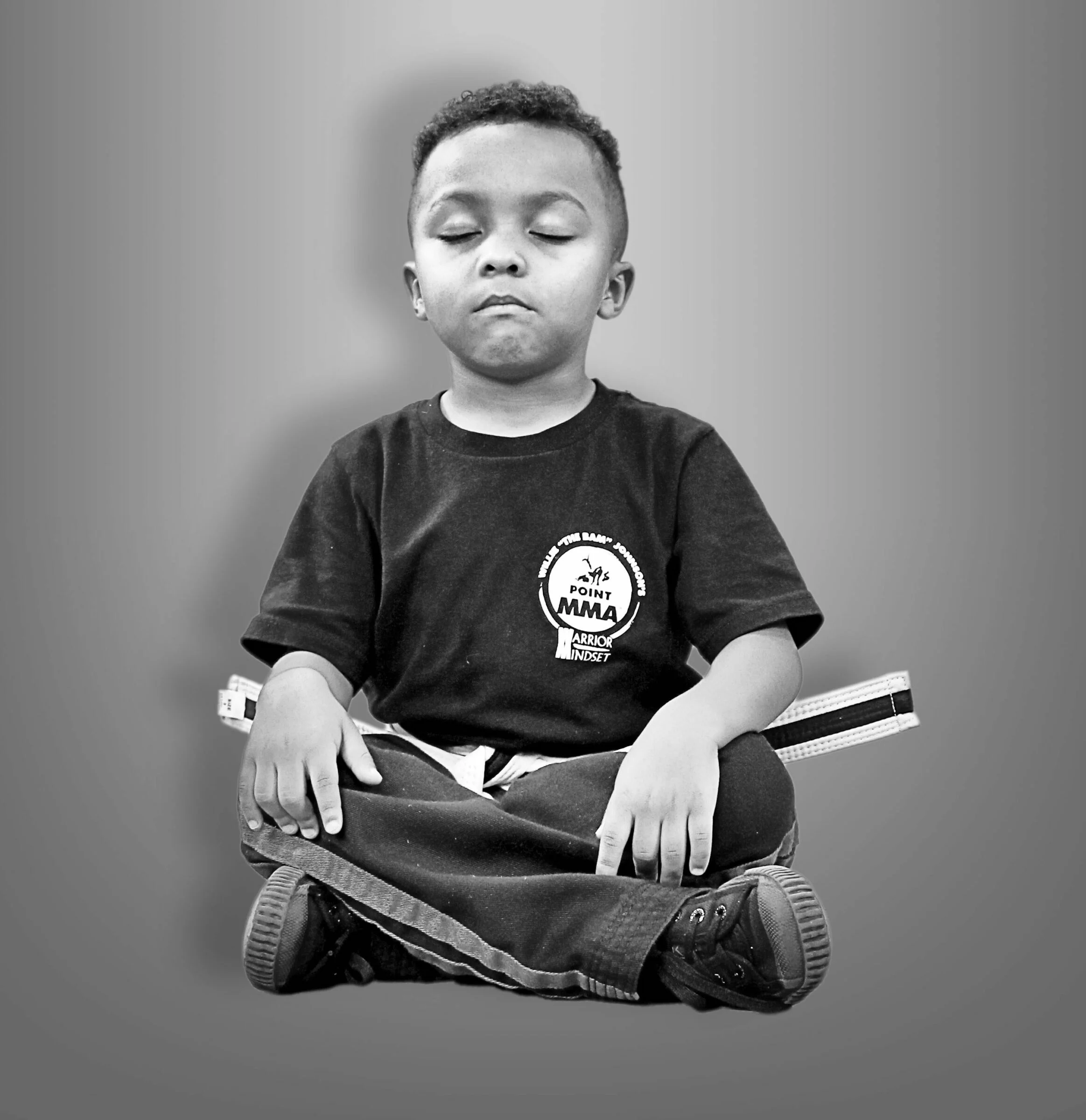 A young student meditating before class